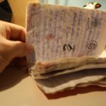 Volles, abgegriffenes Geocache-Logbuch in der Hand